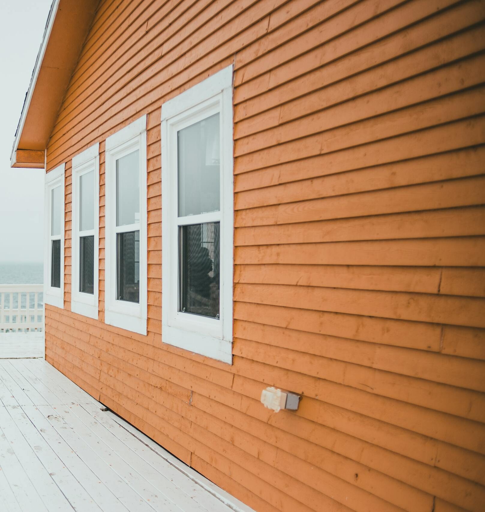 Charming wooden house by the sea with ocean view and bright deck.