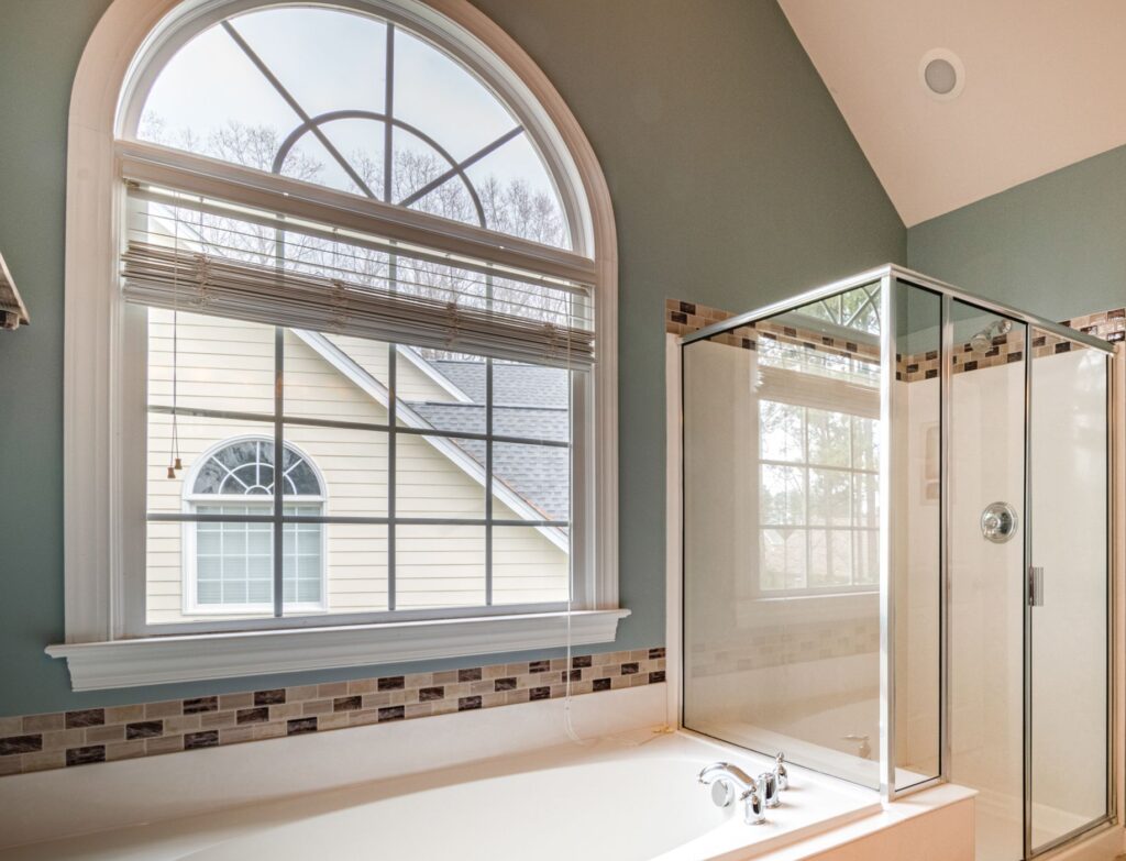 Spacious contemporary bathroom featuring a luxurious bathtub, shower, and adjacent walk-in closet.