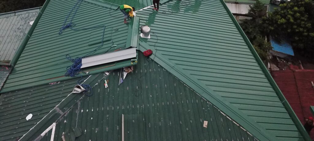Workers installing green roof panels in Caloocan, Philippines.